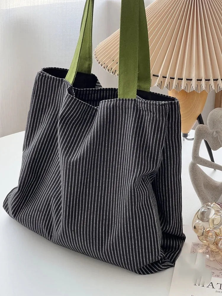 Cotton canvas multi-layer tote shoulder bag in plaid or striped pattern options with wide straps.
