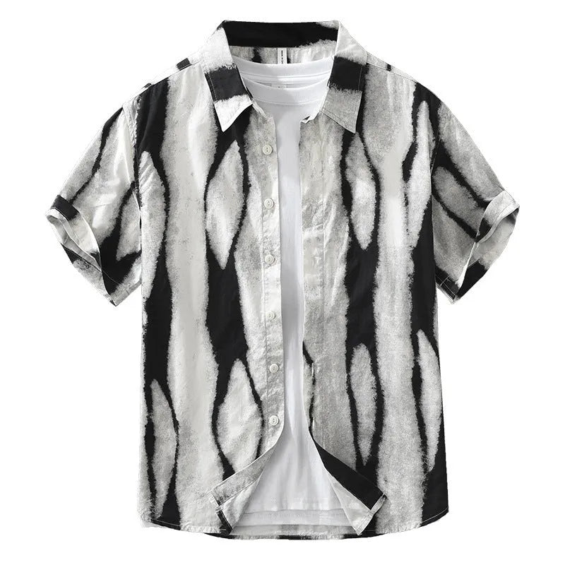 A man wearing a black and white retro striped loose-fit short sleeve cotton shirt.