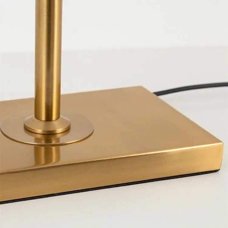 Modern silver floor lamp with adjustable height mechanism and fabric shade, remote control on side table