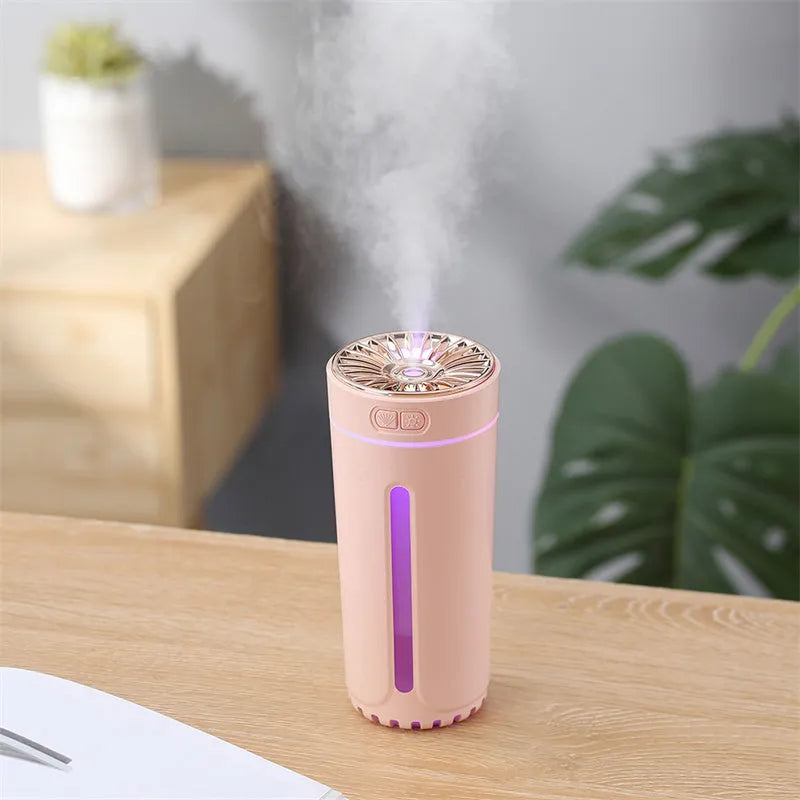 Black USB rechargeable car humidifier with colourful lights showing mist output, sized for cup holders