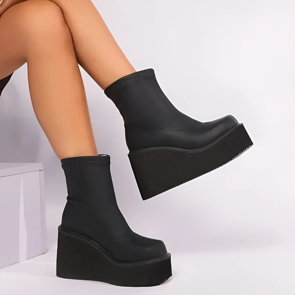 Plus size black women's wedge heel boots with a waterproof platform sole and round toe.