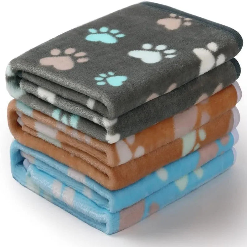Three flannel coral fleece pet blankets in dark grey, camel, and sky blue stacked together showing size S