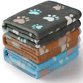 Three flannel coral fleece pet blankets in dark grey, camel, and sky blue stacked together showing size S