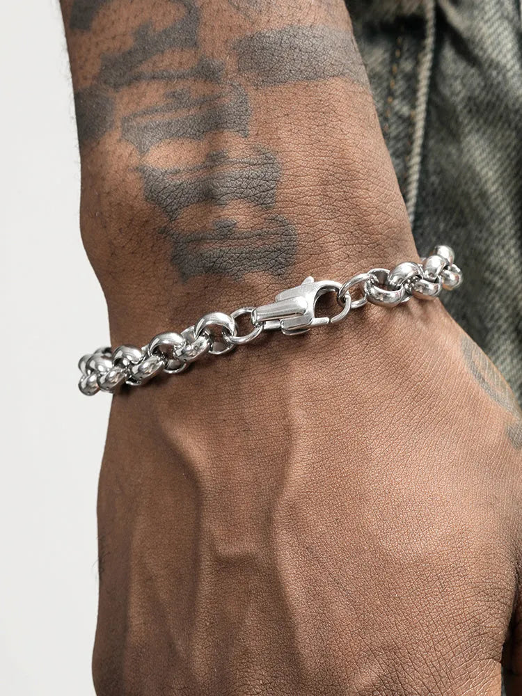 Silver titanium steel bracelet with diamond pattern and O-ring closure on a white background