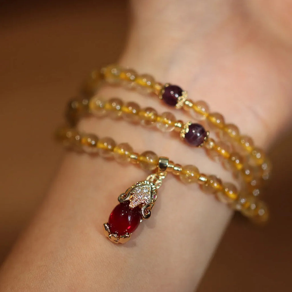 Brazilian rutilated quartz bracelet with Chinese style three-ring gold design in natural gold colour