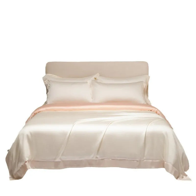 Luxury Lenzing Tencel quilt cover and pillowcases in Aurora Blue on a bed, showing satin weave texture.