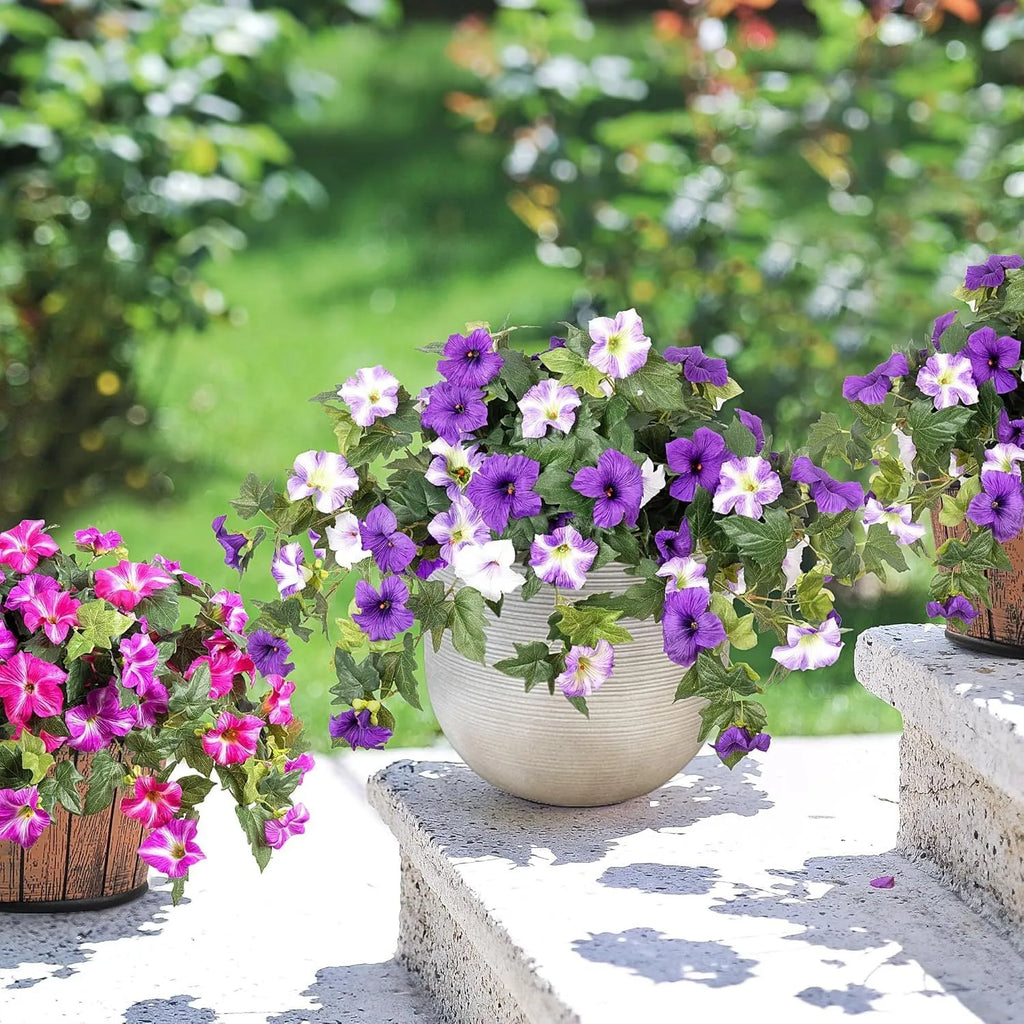 Purple plastic garden container with 12 forks holding red artificial silk flowers on a patio.