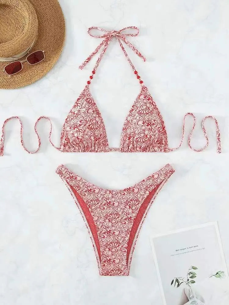 Women's floral bikini halter set with sleeveless top and shorts in polyester fabric.