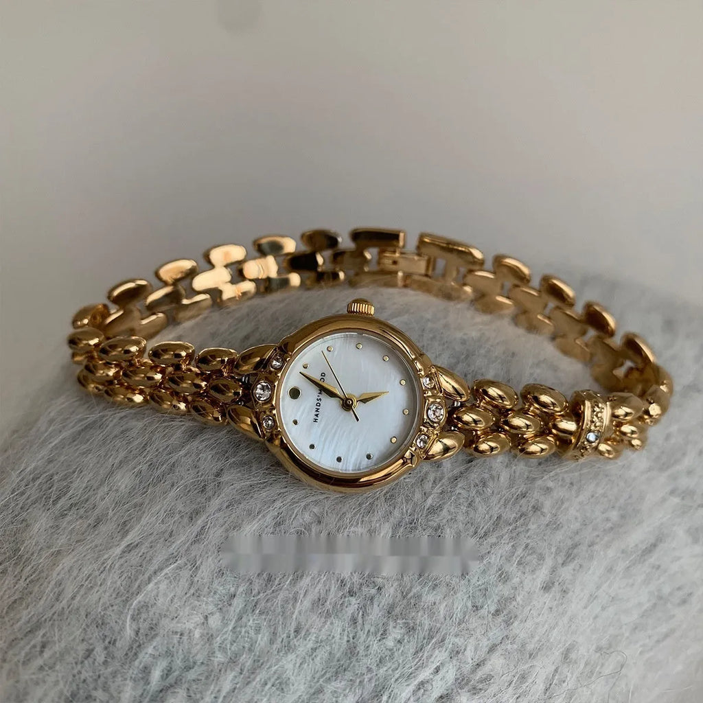Women's gold strap alloy quartz watch with fritillary surface dial and rhinestone accents