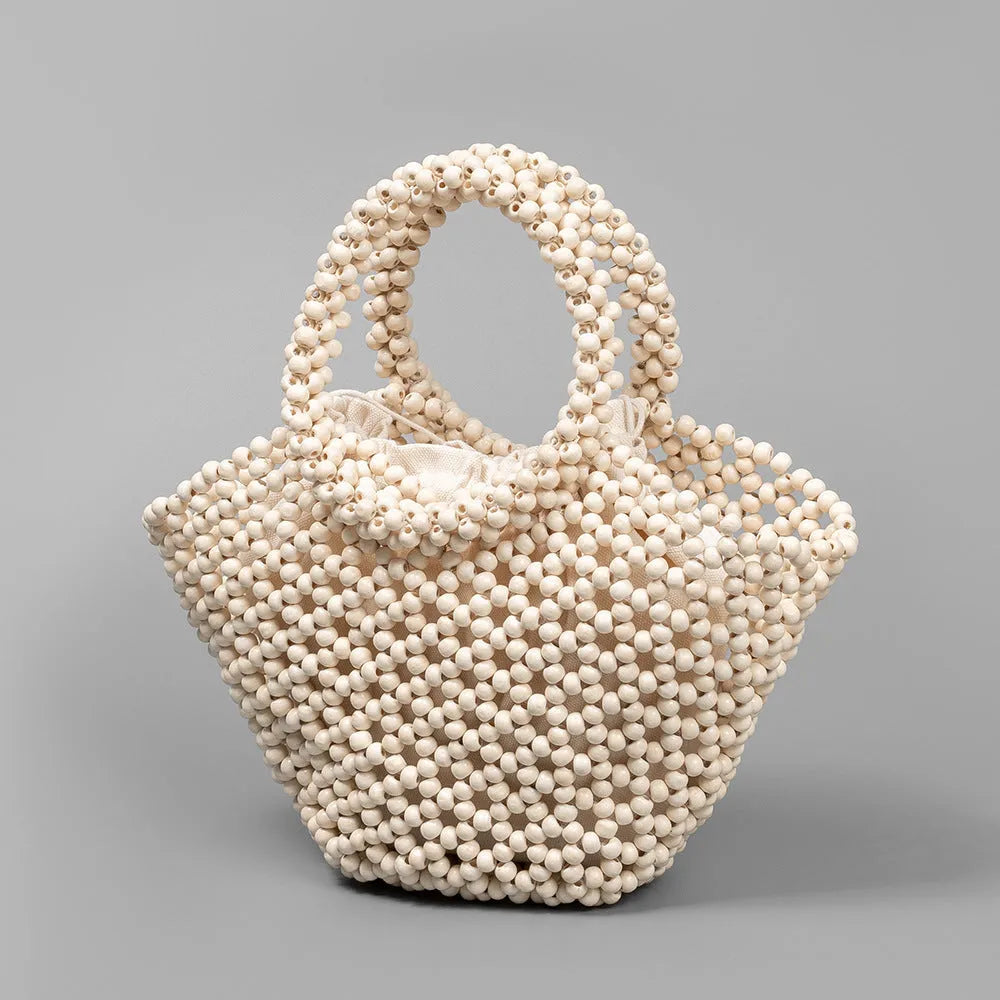 Hand-woven maple wood hollow handbag with wooden bead decoration in dumpling shape