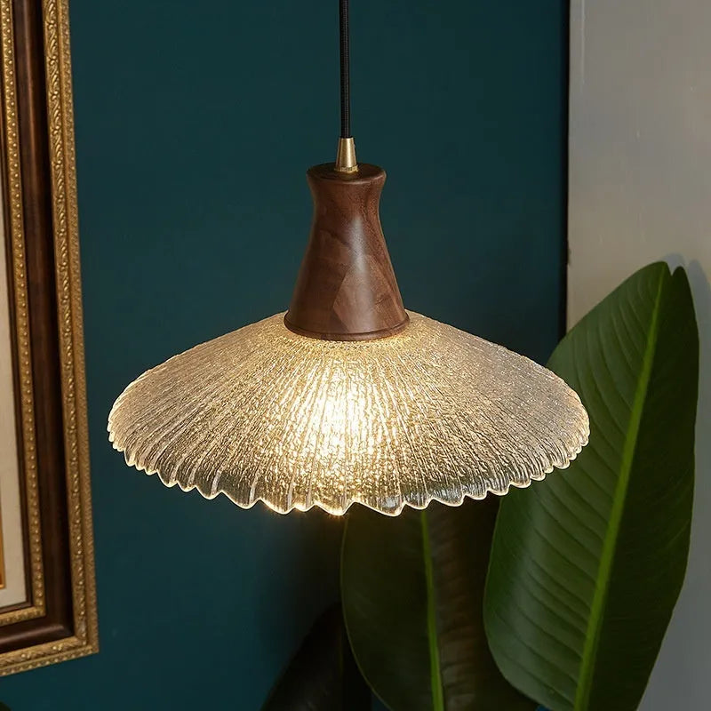 Brass and glass wooden chandelier ceiling light with clear shades in three available sizes.