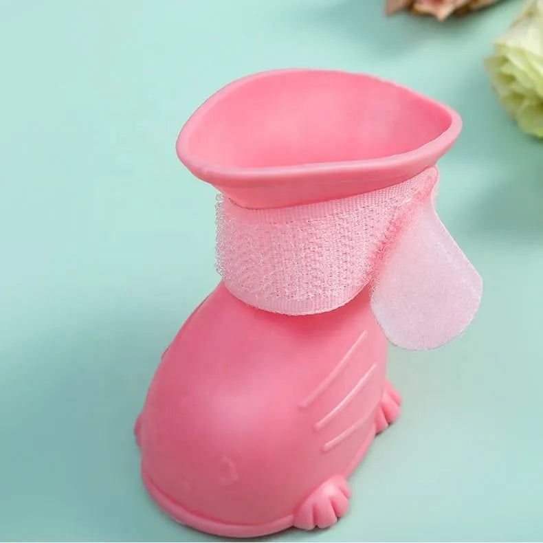 Set of four waterproof silicone dog rain boots in dark blue, gray, light blue, and pink on a white background