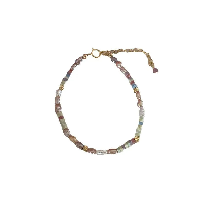 Natural silver pearl bracelet with 14K gilded purple finish and matching necklace on a U-shaped chain.