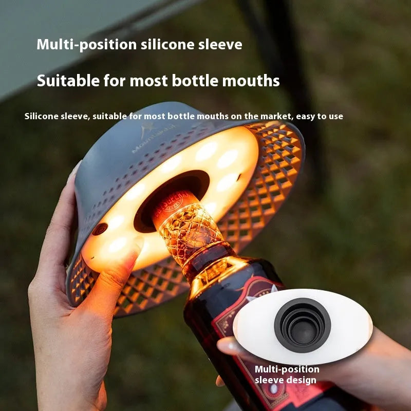 Beige and grey repurposed wine bottle camping lanterns with a gear switch on top for adjusting light mode.