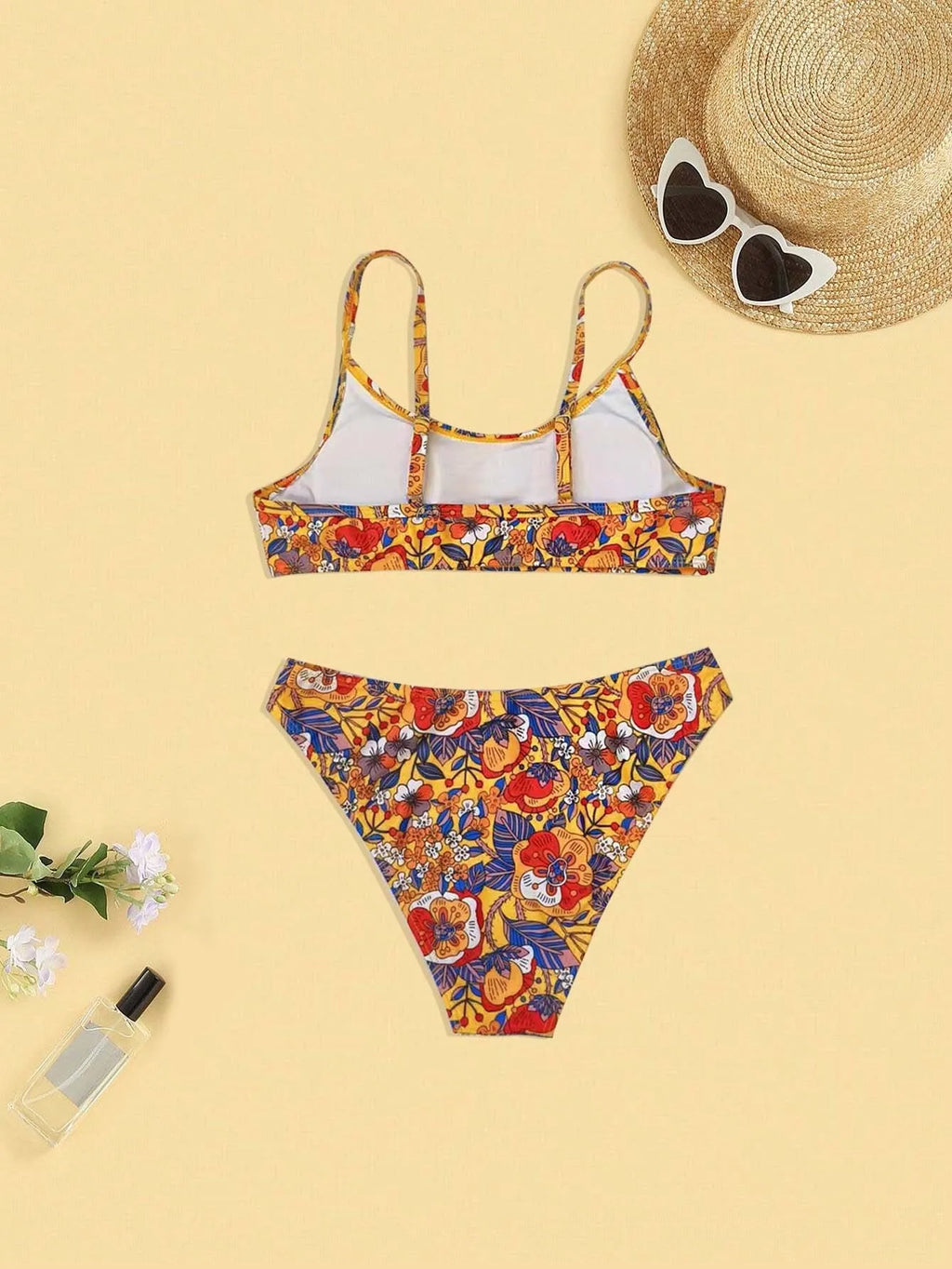 Plus size floral print strapped bikini swimsuit top and briefs on a white background.