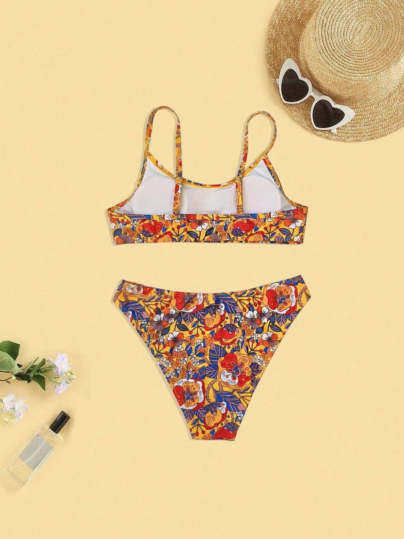 Plus size floral print strapped bikini swimsuit top and briefs on a white background.