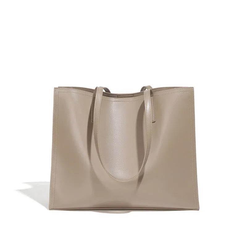 Brown genuine leather women's handbag with single shoulder strap and horizontal square shape