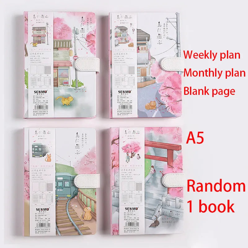 A5 wire-bound retro notebook open showing full-colour vintage illustrations, with a pen.
