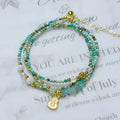 Xiaomi turquoise round bead bracelet with a silver three-ring pull-out adjustable clasp on a wrist.