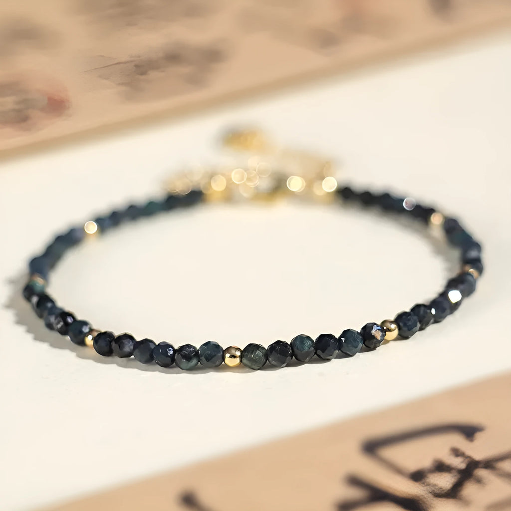 Blue tourmaline bracelet with 3mm beads and silver spacer beads on wrist