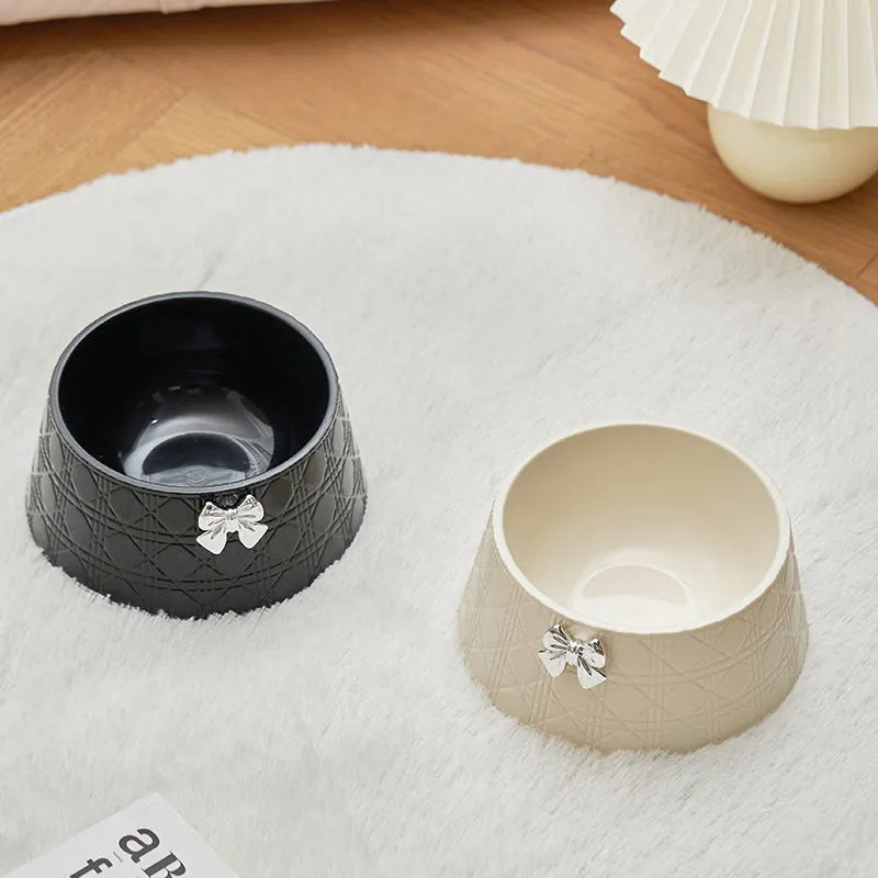Ceramic pet bowl with diamond pattern and bowknot design in black, purple, and white options