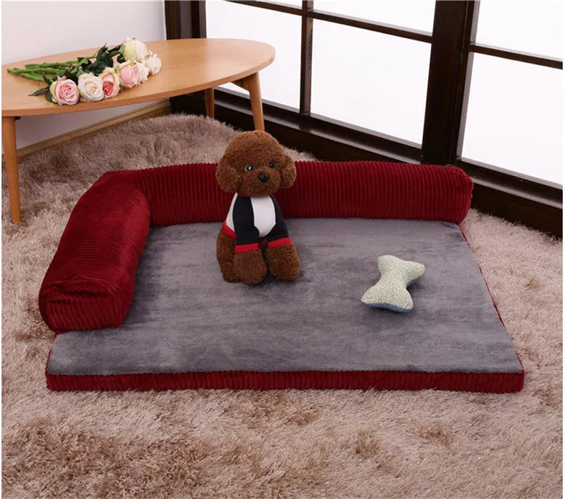 Large grey corduroy dog sofa bed with raised sides on a wooden floor
