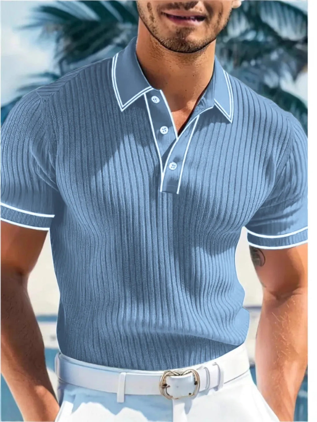 Man wearing a loose-fit striped polo shirt in a summer setting, showing short sleeves and collar detail.