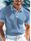 Man wearing a loose-fit striped polo shirt in a summer setting, showing short sleeves and collar detail.