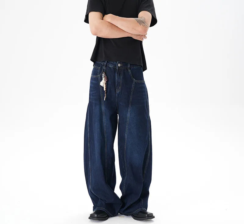 Dark blue washed distressed denim wide leg machete jeans laid flat, showing the wide leg cut and textured finish.