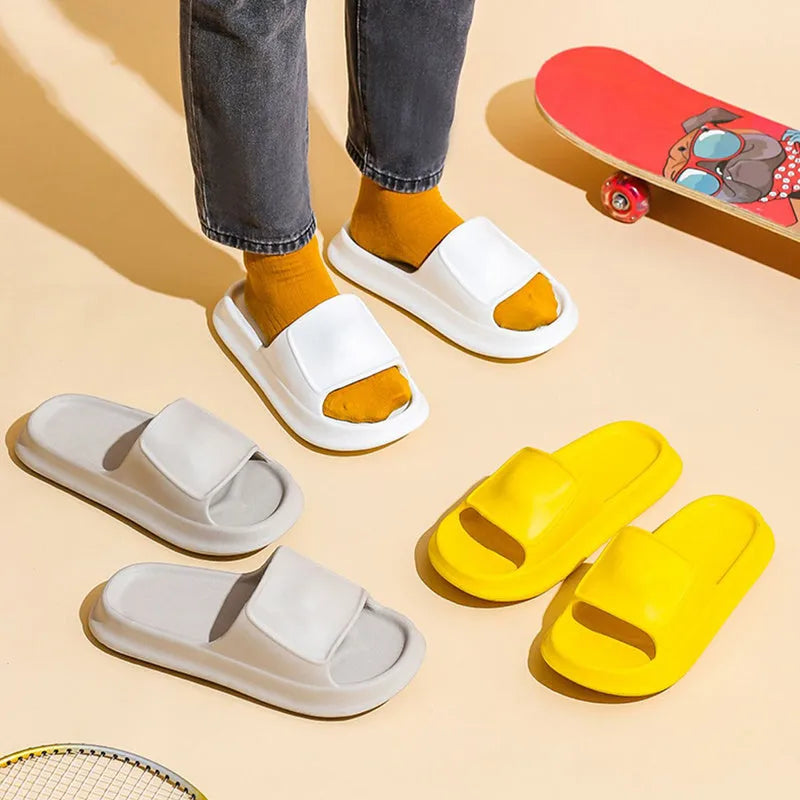 Soft EVA slippers with thick non-slip sole in various colours on a bathroom floor.