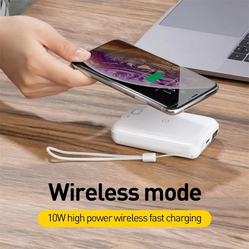 Small square black portable power bank with LED digital display on a table.