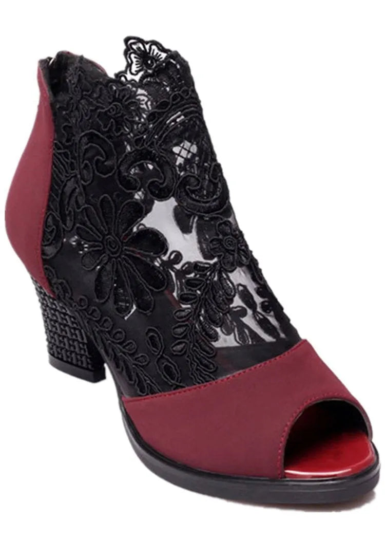 Lucyever women's black gladiator sandals with floral lace upper, square heel, and peep toe on a foot.