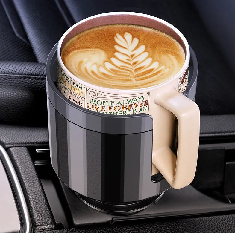 Matte black adjustable car cup holder expander for large bottles and cups on a car console.