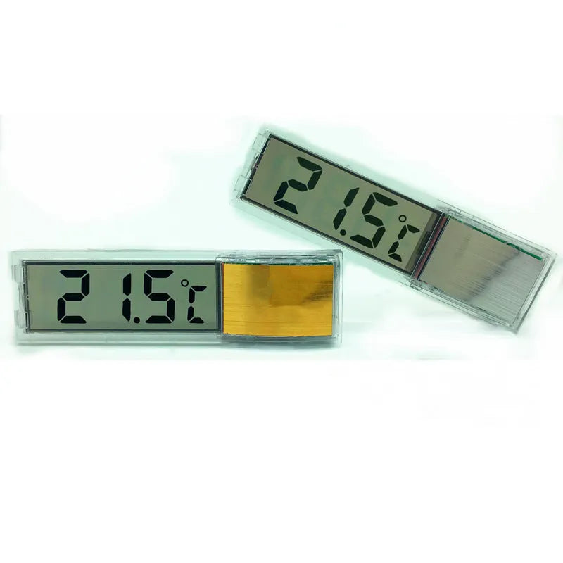 Gold digital stick-on aquarium thermometer on glass tank showing temperature reading