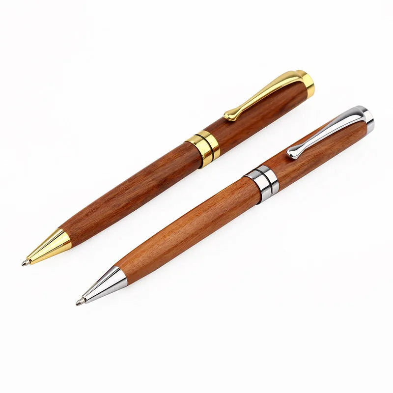 Gold metal and rosewood rollerball pen on a desk, 14cm long