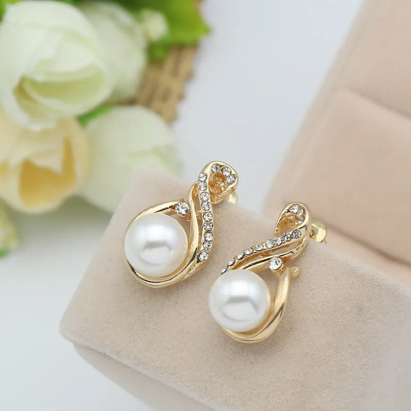 Gold tone pearl necklace and earrings set on display showing CA410-A colour with diamond-cut alloy finish
