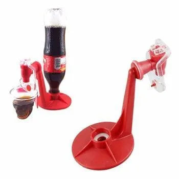 Red Magic Tap plastic soda dispenser attached to an inverted 2-litre bottle on a table.