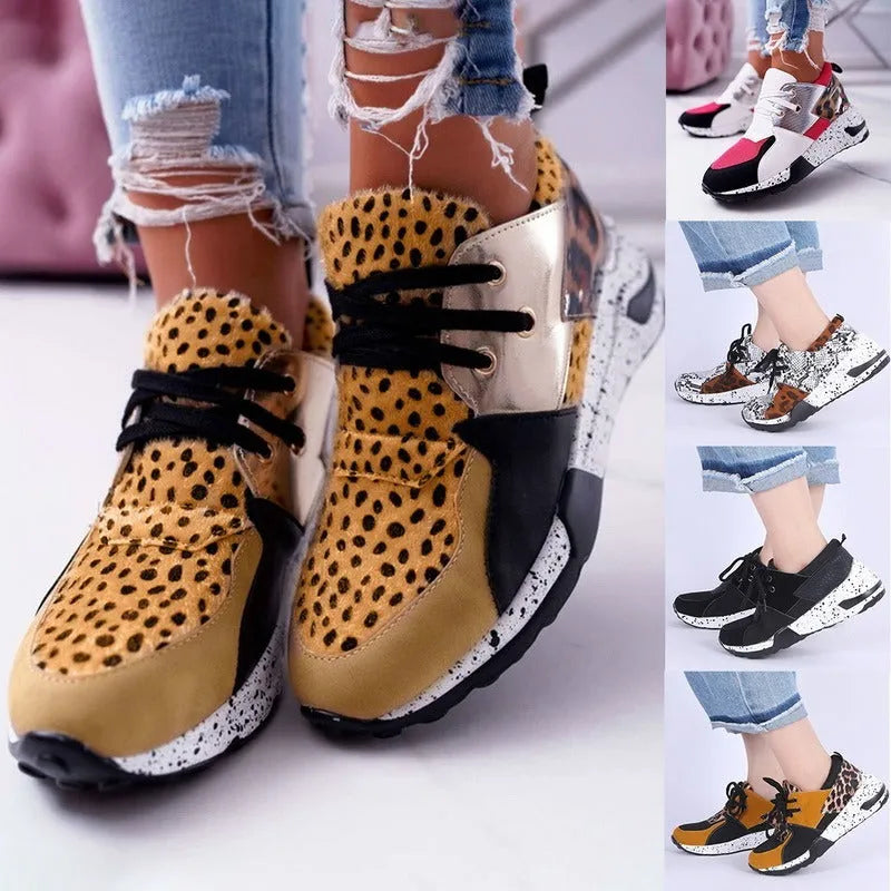 Women's suede sneakers with a wedge heel in leopard print, shown on a foot.