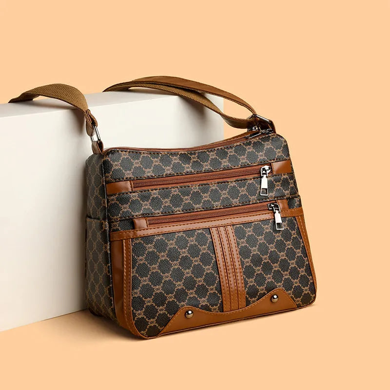 Women's brown and white stitching pattern large-capacity crossbody bag with PU exterior.
