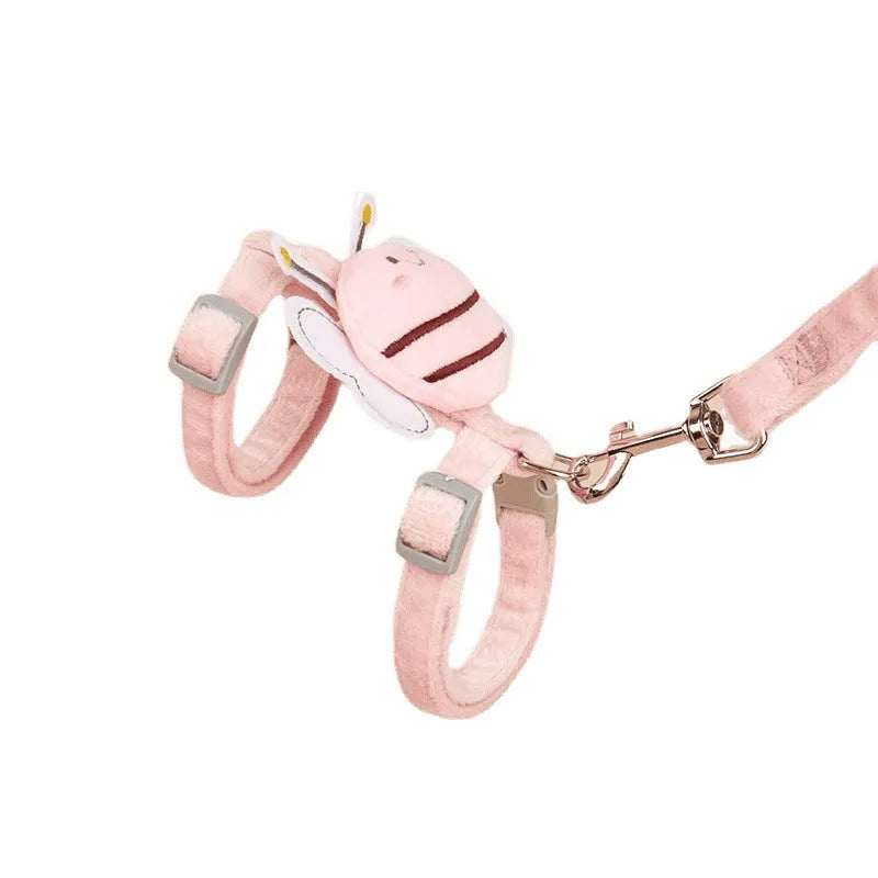 Pink, yellow, and blue bee-shaped adjustable cat leash with strap and hand rope on grass.
