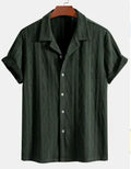 A man's loose-fit, short-sleeve cardigan in a solid colour, shown in black, green, or white.