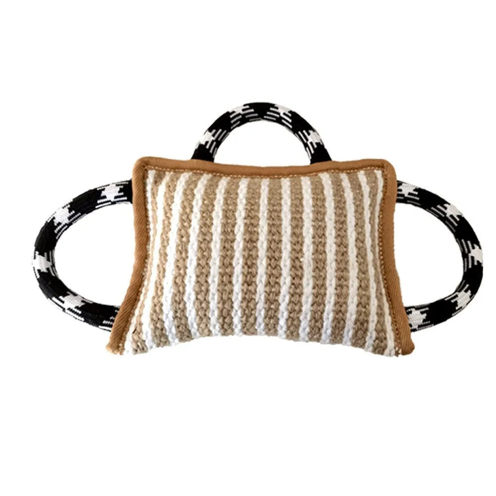 Jute dog tug toy with three rope handles in assorted colours on a neutral background.