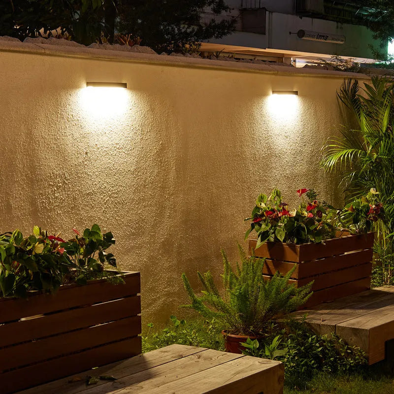 Black solar-powered outdoor wall lamp with strip design for garden and yard lighting