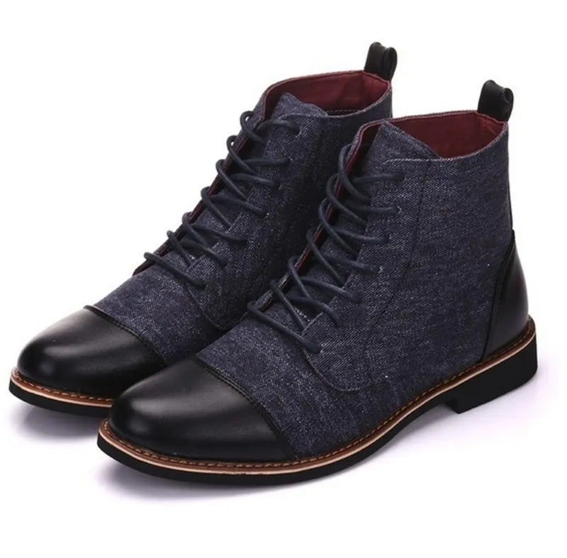 Men's black leather motorcycle boots with metal buckle strap on shaft, shown on a wooden floor.