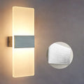 Modern acrylic LED wall lamp in black finish mounted on corridor wall