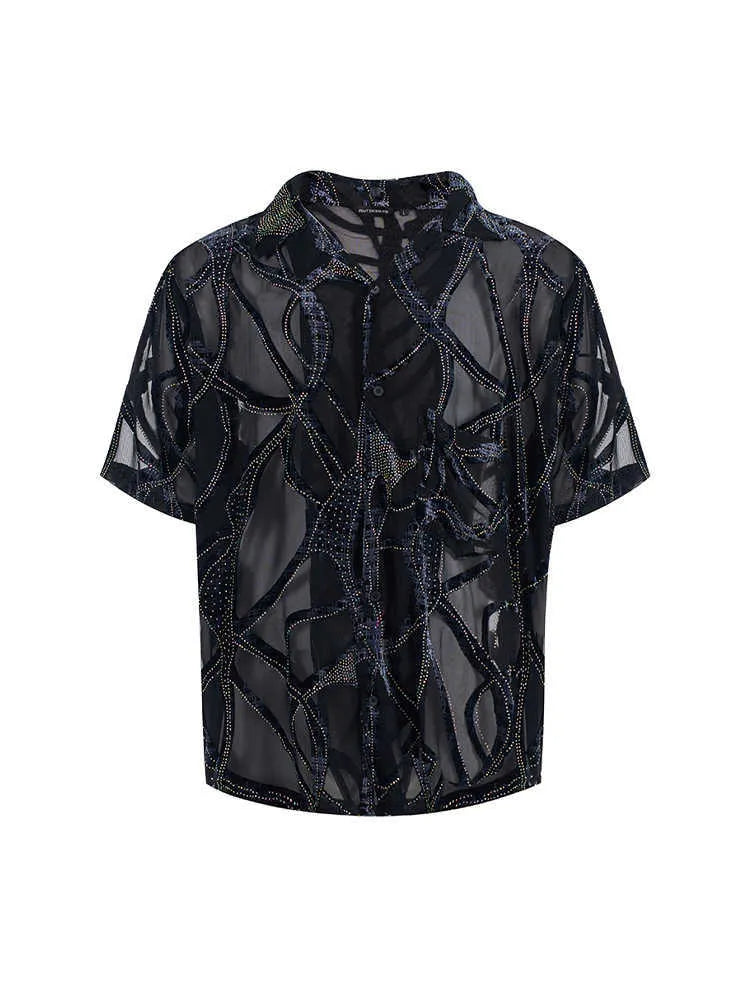 Man wearing a black and grey translucent snake pattern short-sleeved shirt with a lapel collar.