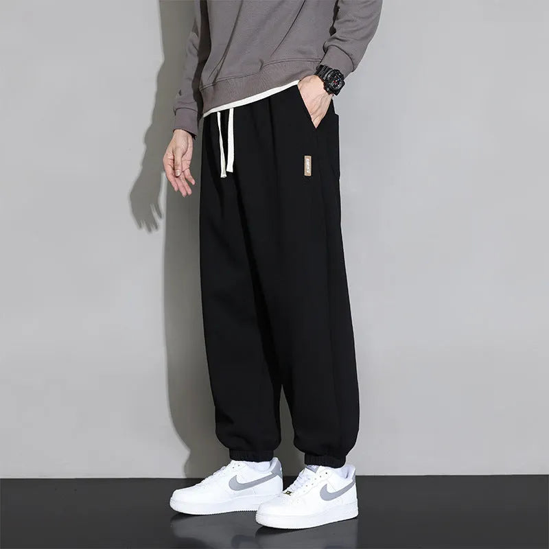 Men's loose grey sports trousers with drawstring waist in cotton-polyester blend
