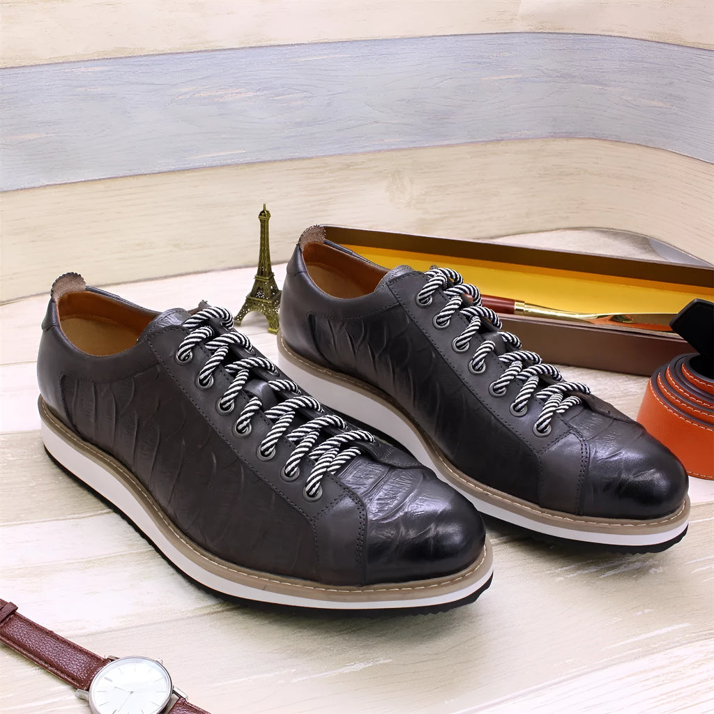 Men's low-top white shoes with embossed pattern texture, featuring lace-up front and microfiber lining.