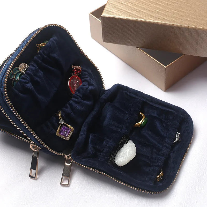 Blue PU zippered jewellery storage bag in handbag shape, 11x11x3.5cm, on a travel background