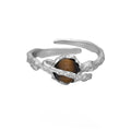 Silver open ring with Saturn design and white gold plating, shown with adjustable opening.